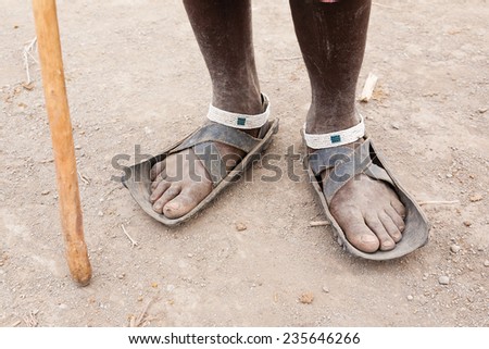 Man's legs in shoes made from old tire,traditional shoes ,Tanzania. Masai man, unrecognizable person