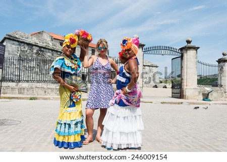 Female tourist posing between Cuban women on the Havana Cuba street,Shallow doff, best focus at the middle woman