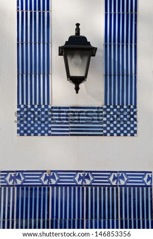 Wall with lamp and blue borders