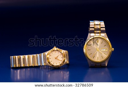 luxurious lady\'s and man\'s watches on a blue background
