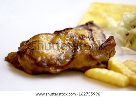 Grilled chicken with fries on a plate