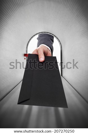Mailman holding a black envelope