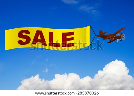 Airplane with sale banner in the sky