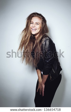A Beautiful Girl Laughs In Studio In Black Jacket
