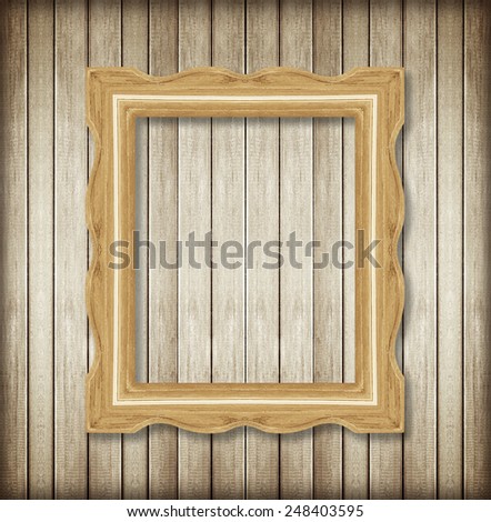 Antique picture frame on wooden wall ;. Empty picture frame on wooden wall.
