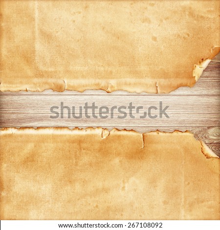 Old torn paper on wood background.