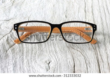 Glasses with Black Frame Fashion  on Wood Background