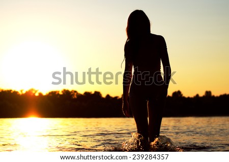 Woman on the beach enjoys the sun