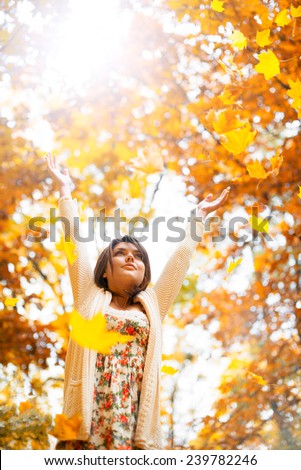 The girl throws the leaves up