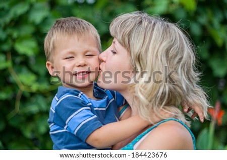 Mom kissing her son