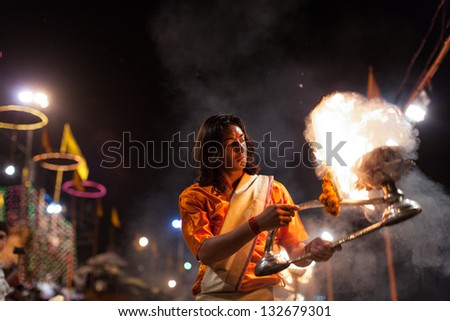 VARANASI,INDIA - MARCH 6:An unidentified Hindu priest performs religious ceremony(fire puja) at Dashashwamedh Ghat on March 6, 2010 in Varanasi,Uttar Pradesh,Central India