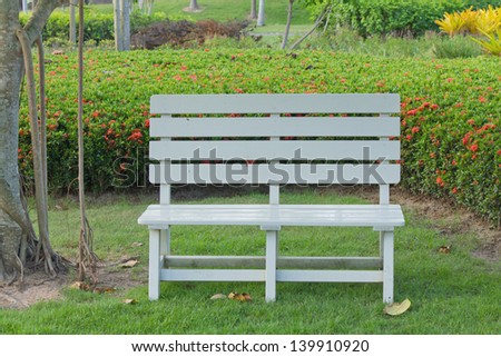 Stock Photo - wooden garden chair in beautiful garden