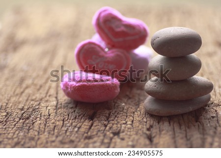 Zen stones and violet Heart on a wooden background, Love vintage concept