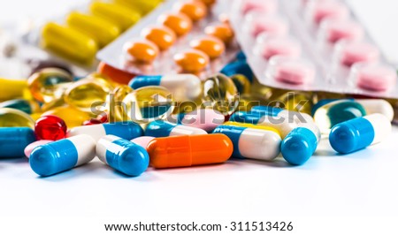 Pills in the flask, vials and the tubes with medications on white background