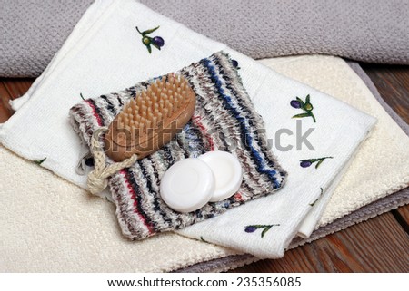 Spa essentials including olive and honey soaps, towels, wash cloths, brush. Selective focus