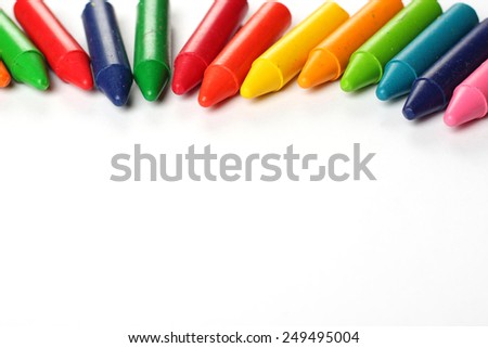 Crayons lying on a paper. Selective focus, copy space background