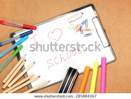Still life, children, school, education concept. Stationery, clips, USB flash drive, stapler,  pens, markers and pencils on a table. Selective focus, copy space background, top view