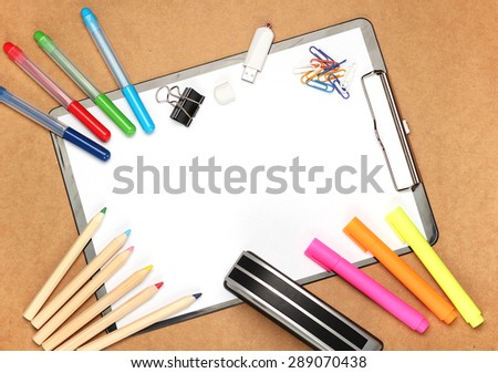 Still life, children, school, education concept.Stationery, clips, USB flash drive, stapler, markers and pencils on a table. Selective focus, copy space background, top view