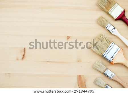 Still life, house and garden concept. Paint brushes on a wooden background. Selective focus, copy space background, top view
