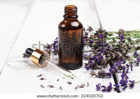 Still life, health and beauty, spa concept. Dry lavender and oil  on a white wooden table. Selective focus