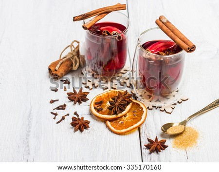 Still life, food and drink, seasonal and holidays concept. Christmas mulled wine on a white rustic \
wooden table. Selective focus, copy space background