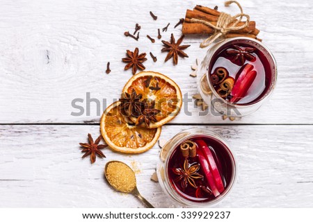 Still life, food and drink, seasonal and holidays concept. Christmas mulled wine on a white rustic \
wooden table. Selective focus, copy space background, top view