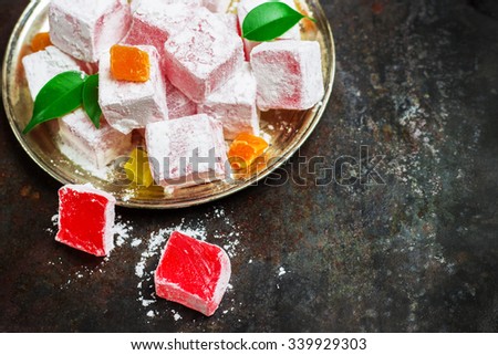Still life, food and drink, seasonal and holidays (ramadan, seker bayram) concept. Rose turkish delight on a metal grunge table. Selective focus, copy space background, top view