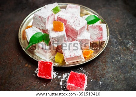 Still life, food and drink, seasonal and holidays (ramadan, seker bayram) concept. Rose turkish delight on a metal grunge table. Selective focus