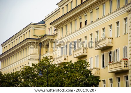 Tbilisi city view - reconstructed building at the street with trees, side view