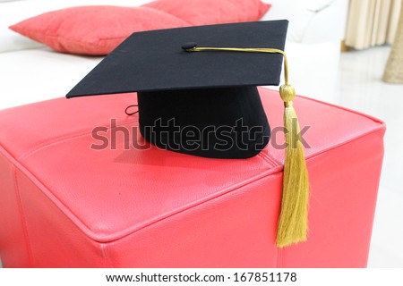 Traditional university black hat with golden bow.
