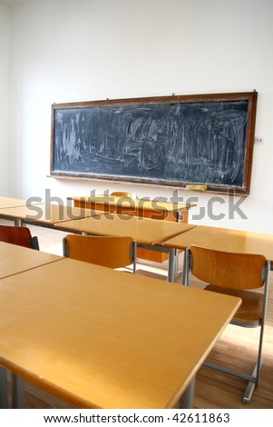 traditional classroom interior with blackboard and desks