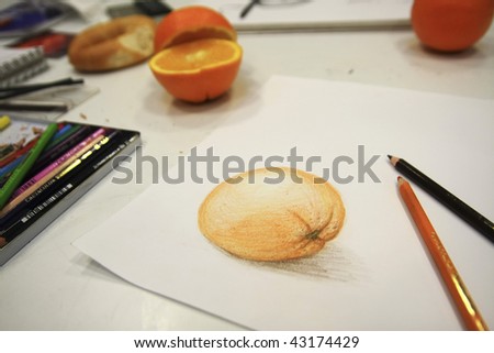 Picture of orange drawing and pencils