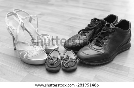 Three pairs of shoes: men, women and children - Family