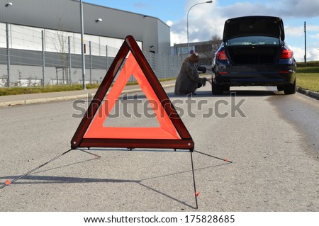 Broken car, girl and warning triangle