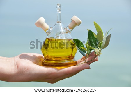 Bottle of olive oil in the hand