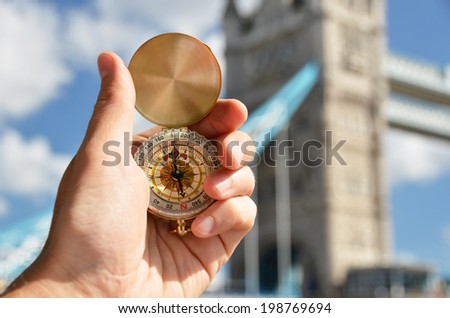 Compass in the hand against Tower bridge in London