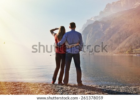 A couple at a mountain lake