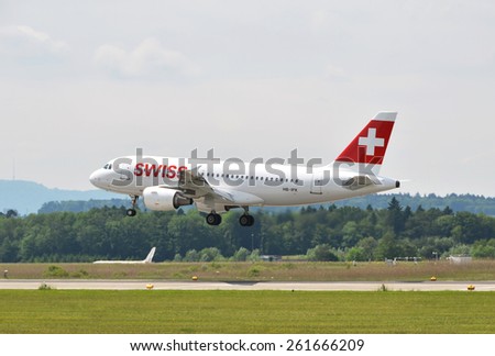 ZURICH, SWITZERLAND - MAY 25, 2014: Swiss airplane landing at Zurich international airport. Zurich International Airport is one of the major Europian Hubs and the home port of Swiss airline.