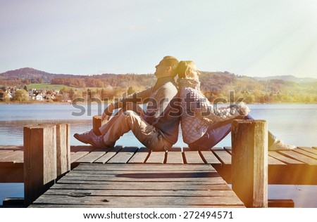A couple on the wooden jetty at a lake. Switzerland