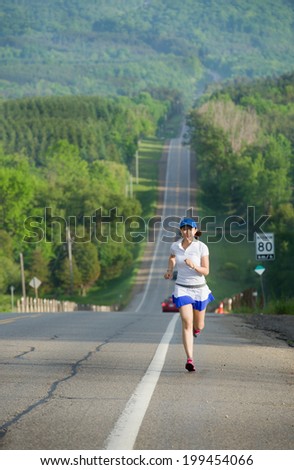 Asian woman active in forest. running. Girl running at great speed.