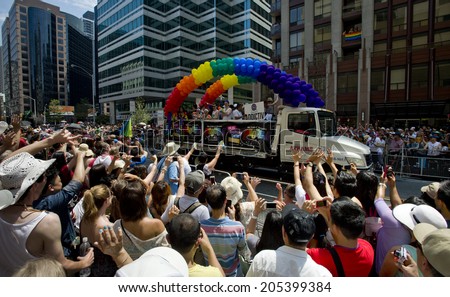 toronto - june29: festival goers hold the rainbow banner at the toronto ,canada on June 29 , 2014