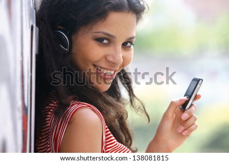 Jolly young woman in headphones listen to music
