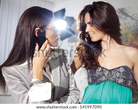 Attractive business women look at face to face