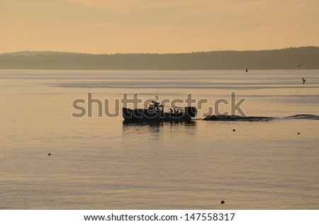 Lobster fisherman in their boat on an early morning in Maine