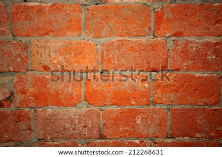 A red brick and mortar wall background.
