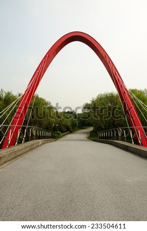 An arched metal bridge support and paved roadway in Jiading area of Shanghai China.
