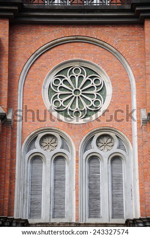 Close up details of a window on a gothic designed brick church located in Shanghai Film Park.