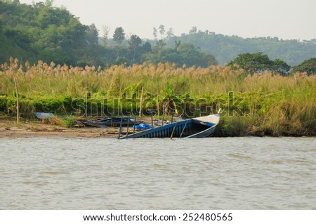 A half sunken boat washed ashore on the Mekong River in Thailand.