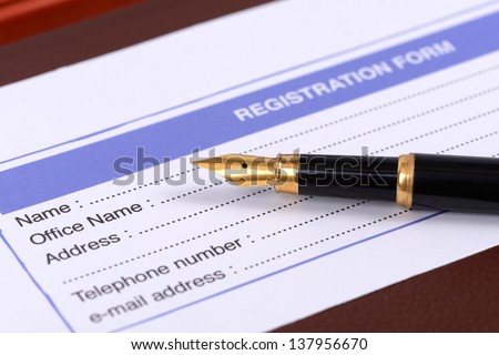 Registration card with pen ready to sign up.