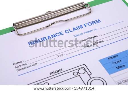 Closeup of insurance claim form on clipboard.